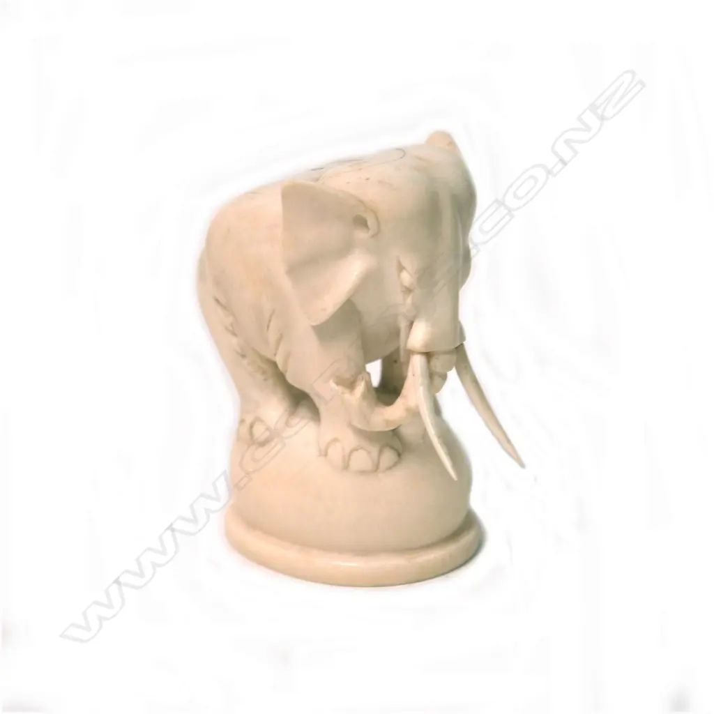 An early 20thC solid carved ivory elephant on ball stand Image 1++