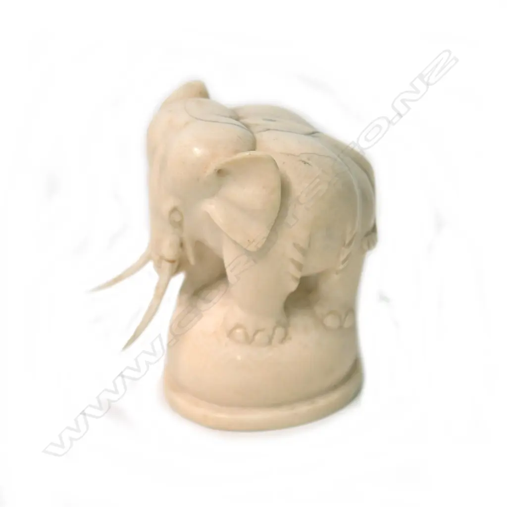 An early 20thC solid carved ivory elephant on ball stand Image 1++