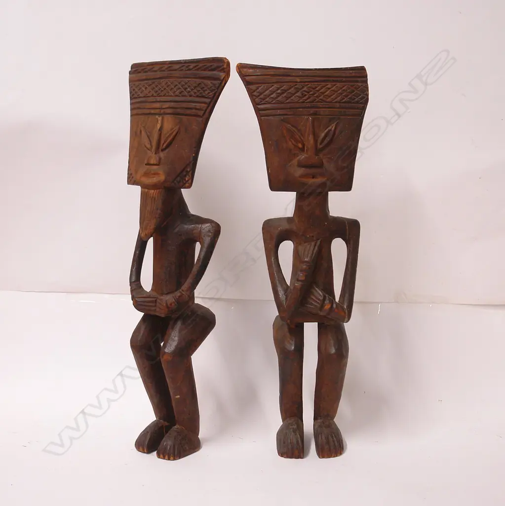 A pair of old West African carved wood stylised figures Image 1++