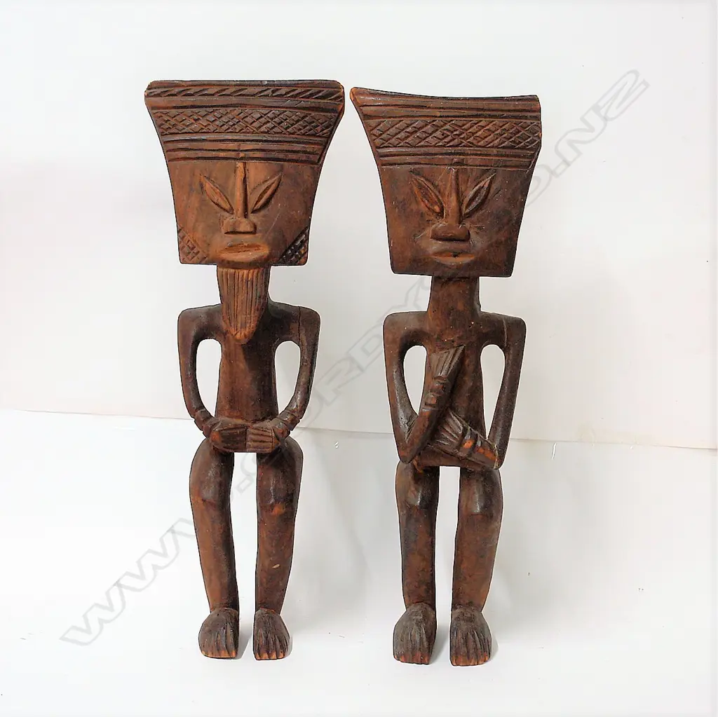 A pair of old West African carved wood stylised figures Image 1++