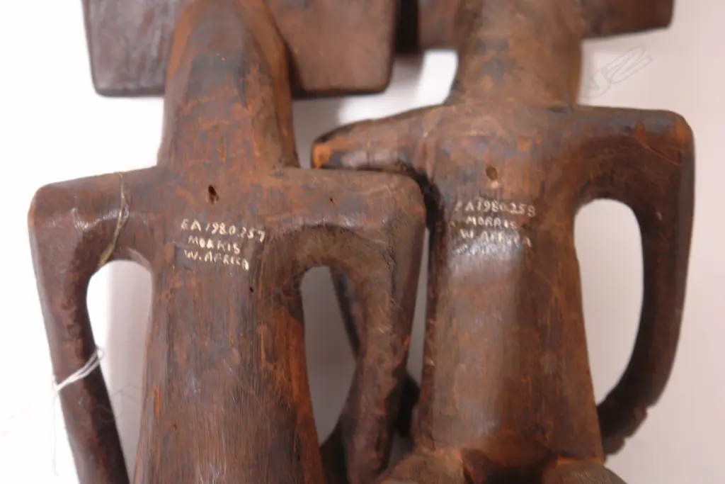 A pair of old West African carved wood stylised figures Image 1++