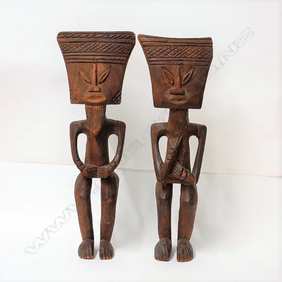 A pair of old West African carved wood stylised figures
