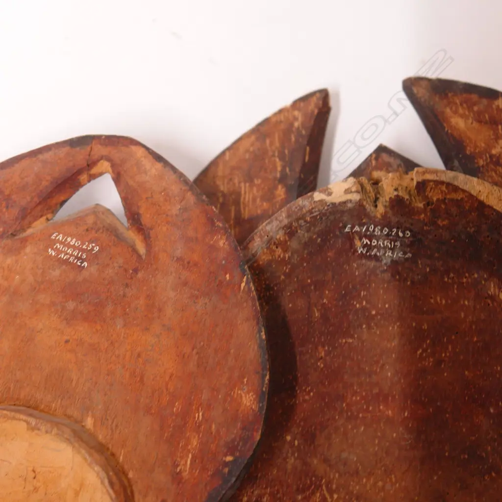 Two West African carved wooden tribal masks Image 1++