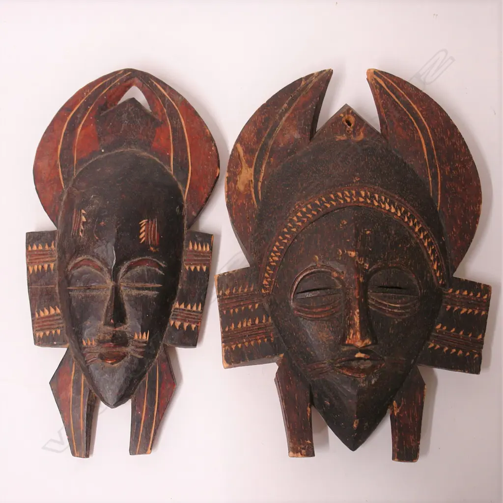 Two West African carved wooden tribal masks Image 1++