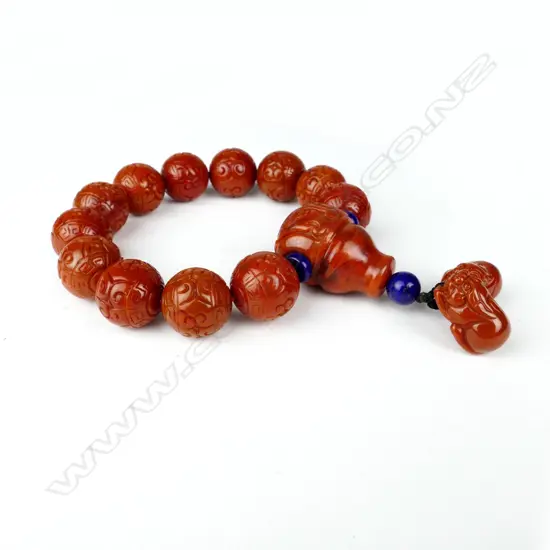 A Chinese carved orange agate bead bracelet
