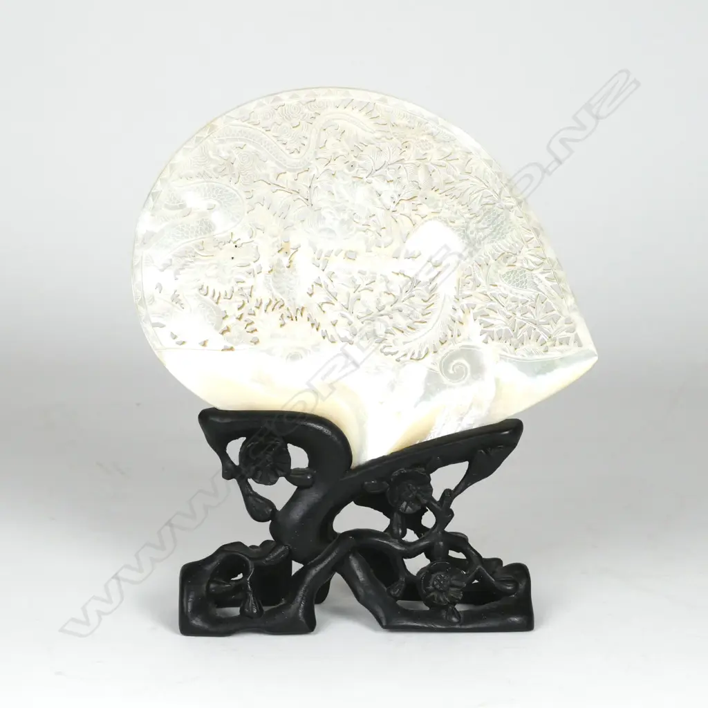A mother-of-pearl shell on stand Image 1++