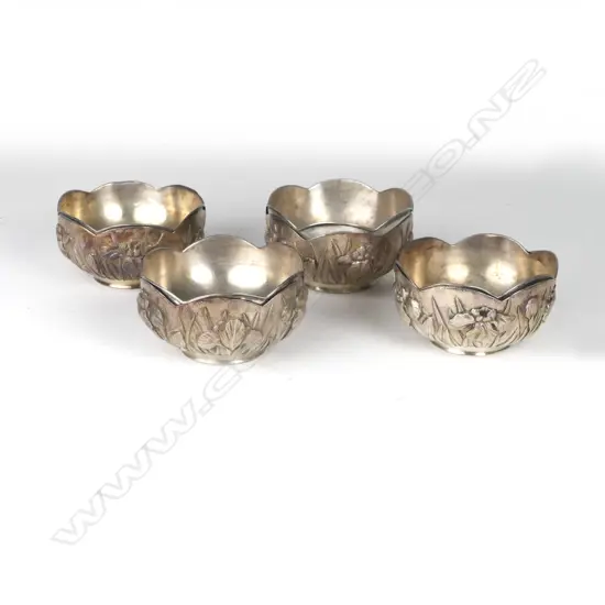 A matching set of four Japanese silver bowls with shaped borders