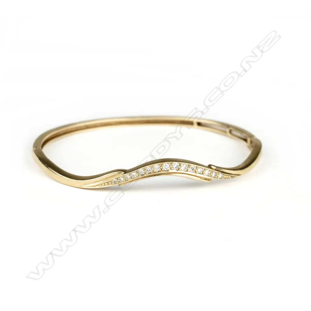 A vintage lady's 9ct. yellow gold and diamond hinged bangle Image 1++