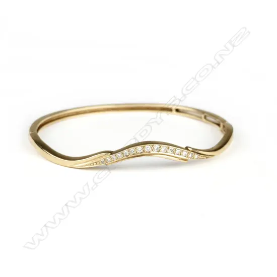 A vintage lady's 9ct. yellow gold and diamond hinged bangle