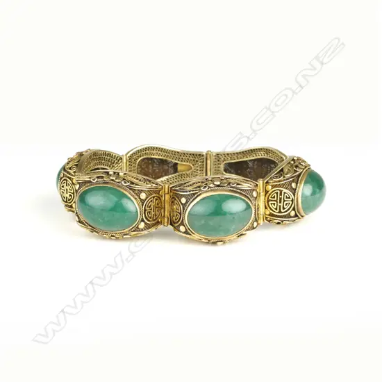 A mid-20thC Chinese silver gilt and jadeite panelled bracelet