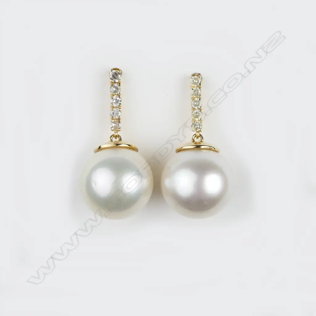 A pair of 14ct. pearl and diamond drop earrings Image 1++
