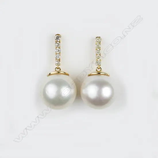 A pair of 14ct. pearl and diamond drop earrings