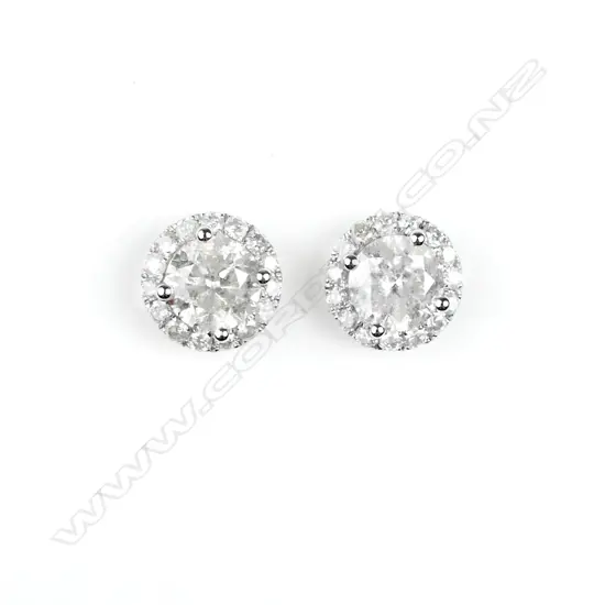 A pair of 14ct. white gold and diamond stud earrings