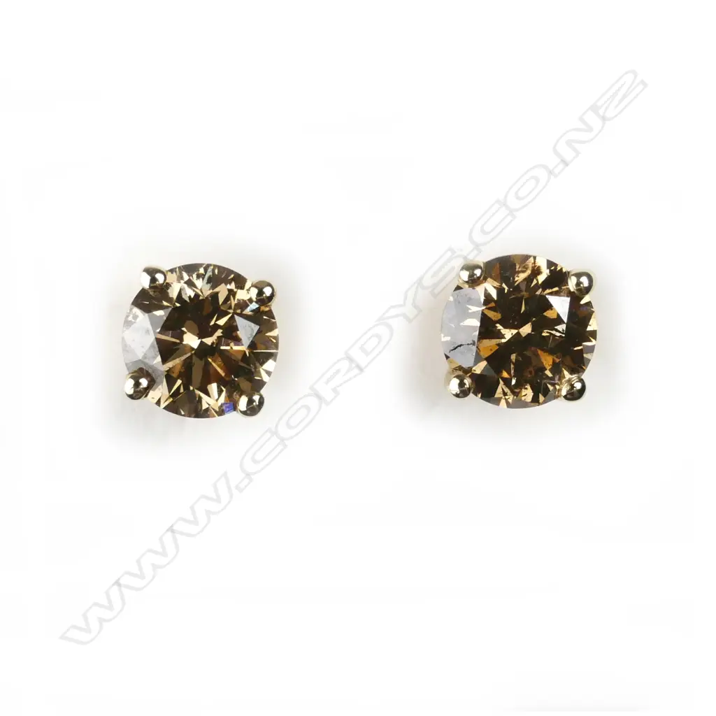 A pair of 14ct. gold and diamond stud earrings Image 1++
