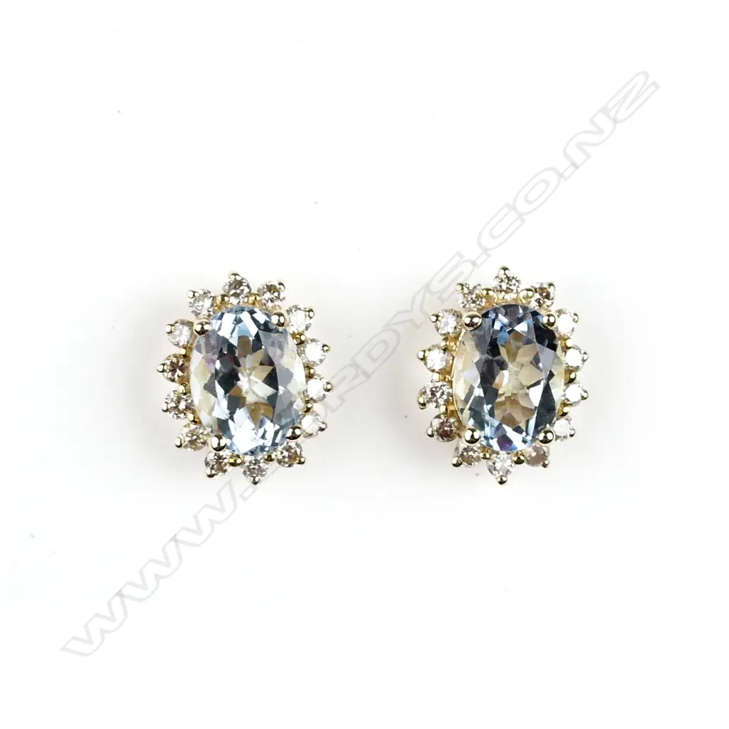 A pair of 14ct. gold aquamarine and diamond stud earrings Image 1++