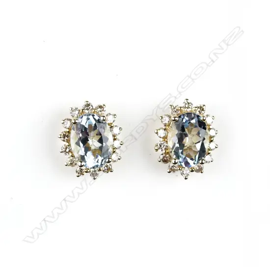 A pair of 14ct. gold aquamarine and diamond stud earrings