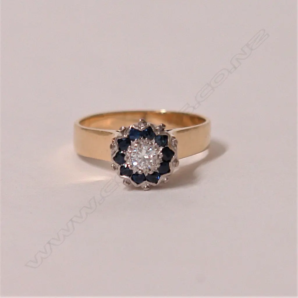 A lady's estate 9ct. yellow and white gold sapphire and diamond cluster ring Image 1++