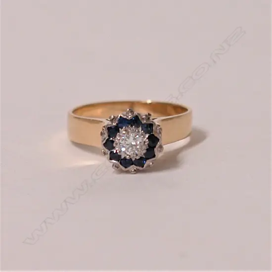 A lady's estate 9ct. yellow and white gold sapphire and diamond cluster ring