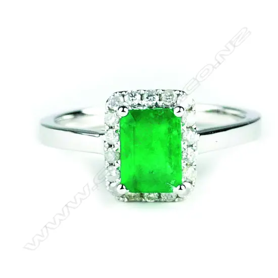 A 14ct. white gold emerald and diamond ring