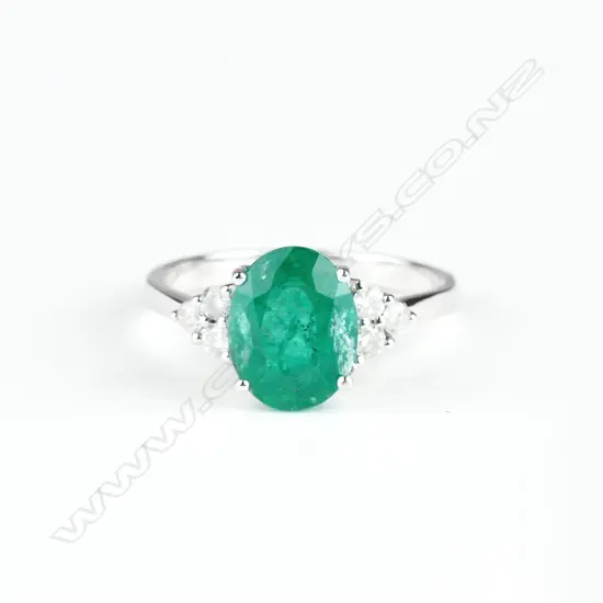 A 14ct. white gold emerald and diamond ring