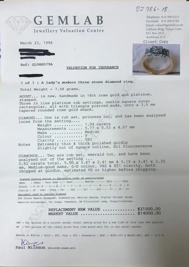 A modern 18ct. yellow and white gold three-stone diamond ring Image 1++