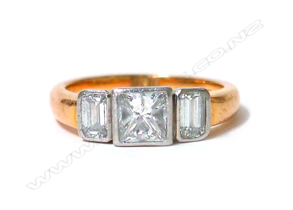 A modern 18ct. yellow and white gold three-stone diamond ring Image 1++