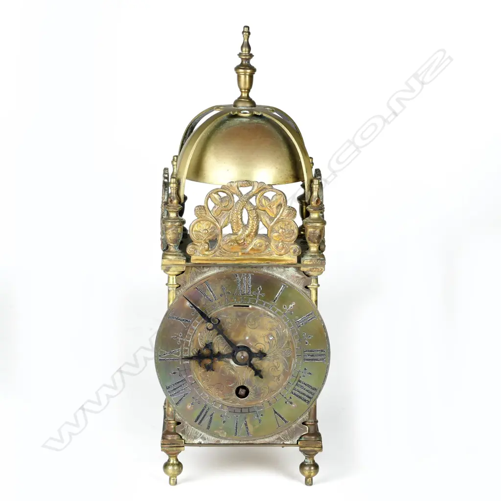 A timepiece in a lantern clock type case Image 1++