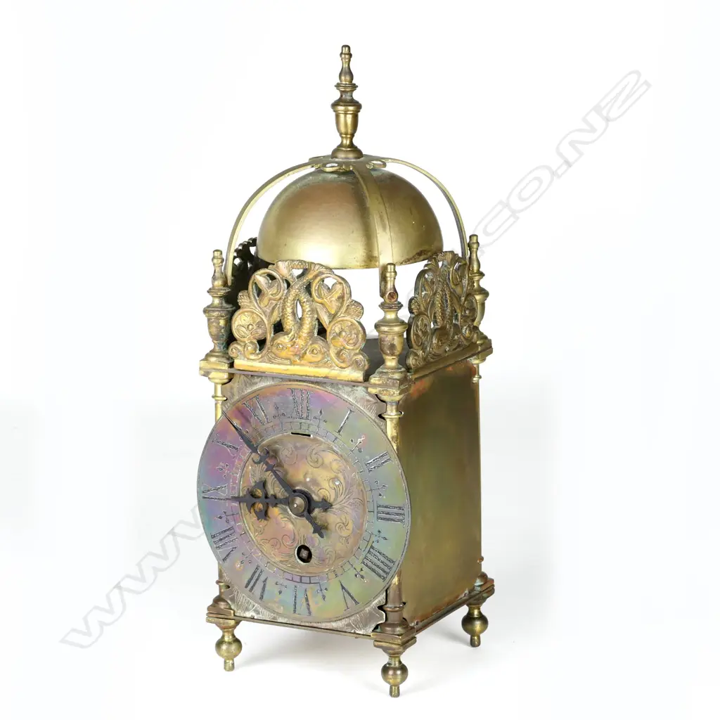 A timepiece in a lantern clock type case Image 1++