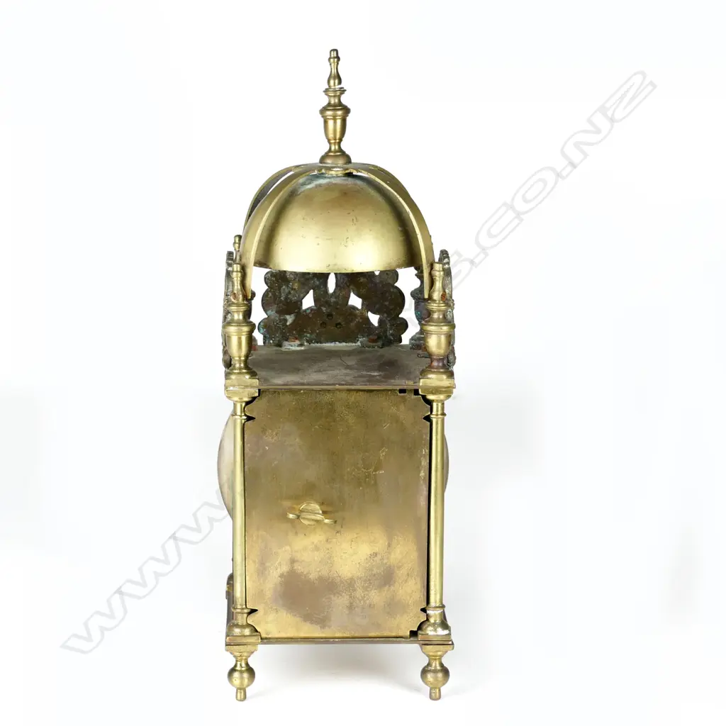 A timepiece in a lantern clock type case Image 1++