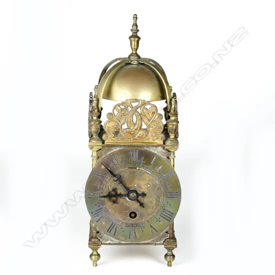 A timepiece in a lantern clock type case