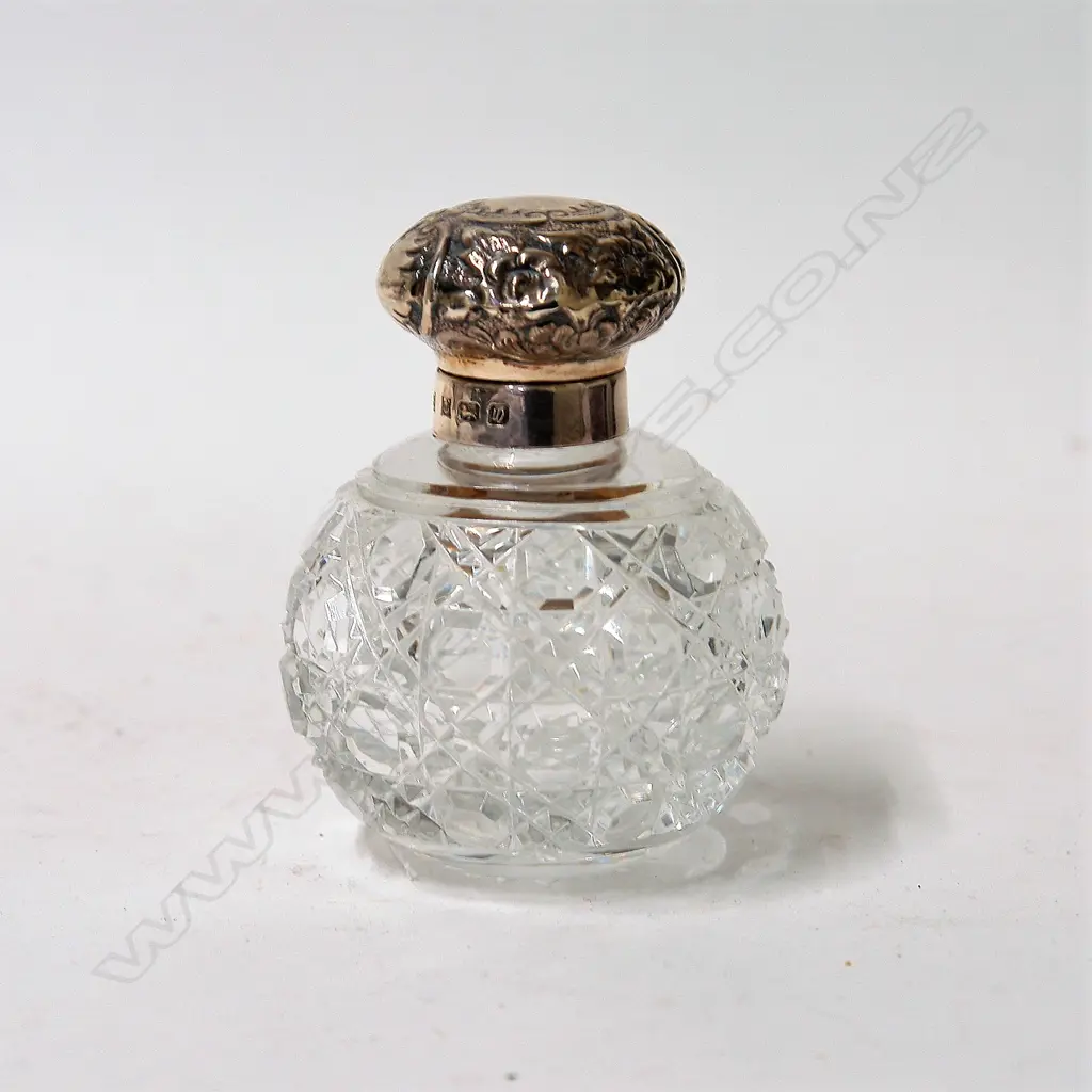 An embossed silver topped cut crystal scent bottle Image 1++
