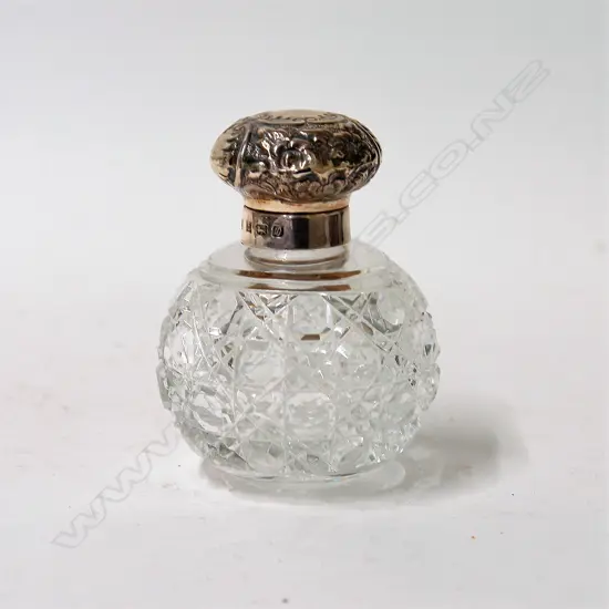 An embossed silver topped cut crystal scent bottle