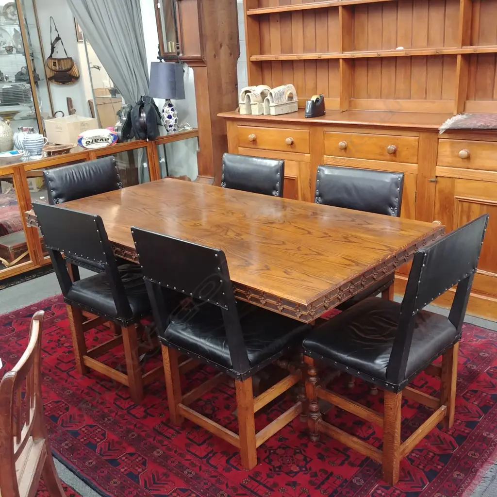 A c.1910 refectory oak dining table and six oak and leather upholstered chairs Image 1++