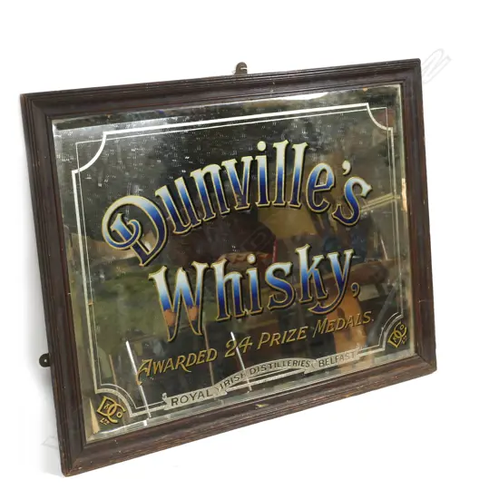 A vintage whisky advertising mirror
