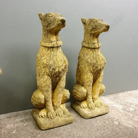 A pair of church stone classical seated hound dogs