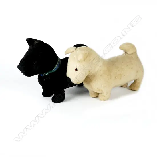 Two vintage black and white plush toy dogs