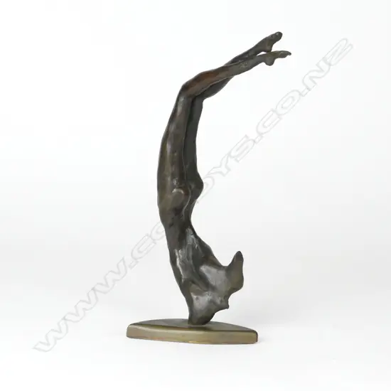 A bronze figure of a stylised acrobatic naked female figure