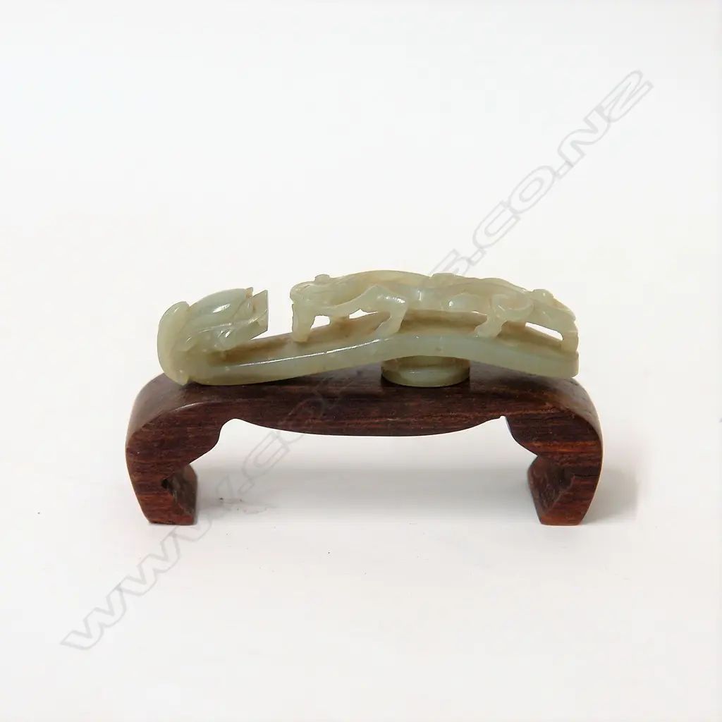 A Chinese carved pale green jade belt hook Image 1++