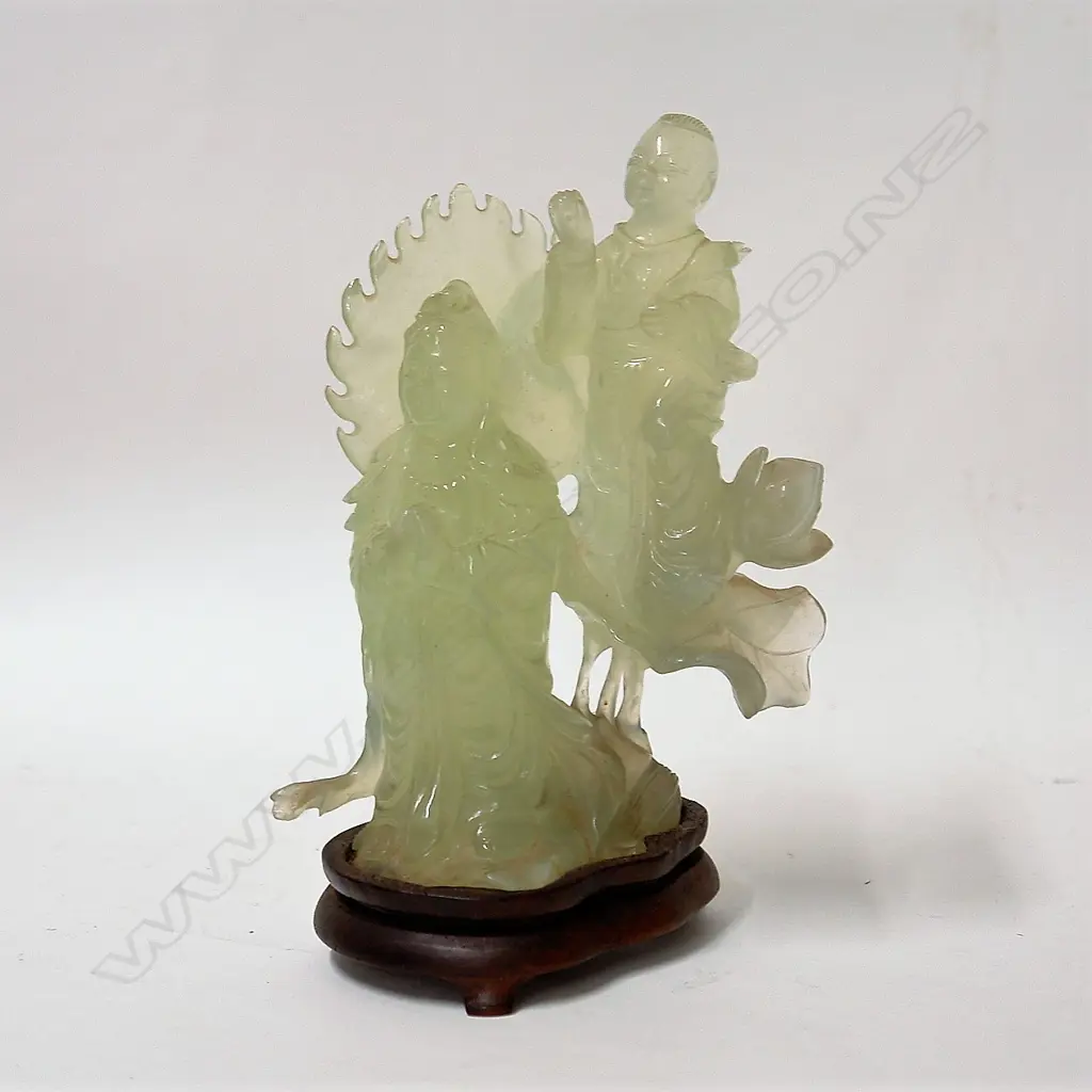 A Chinese carved pale jade figure group of a praying deity with boy attendant Image 1++