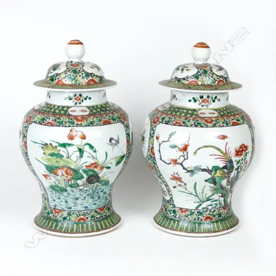 A pair of large Chinese lidded famille verte baluster vases painted with panels of birds