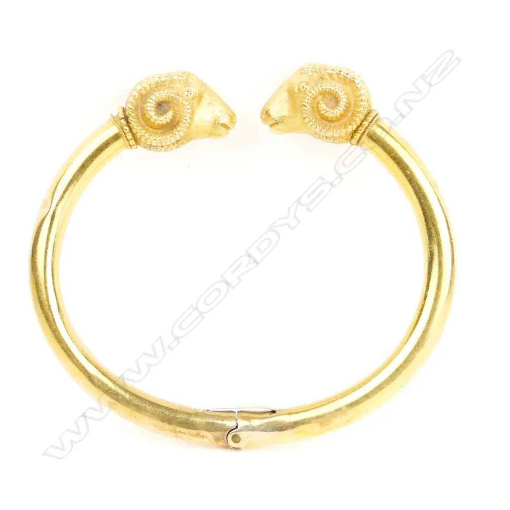 A late 19thC 14ct. yellow gold double ram's head hinged bangle Image 1++