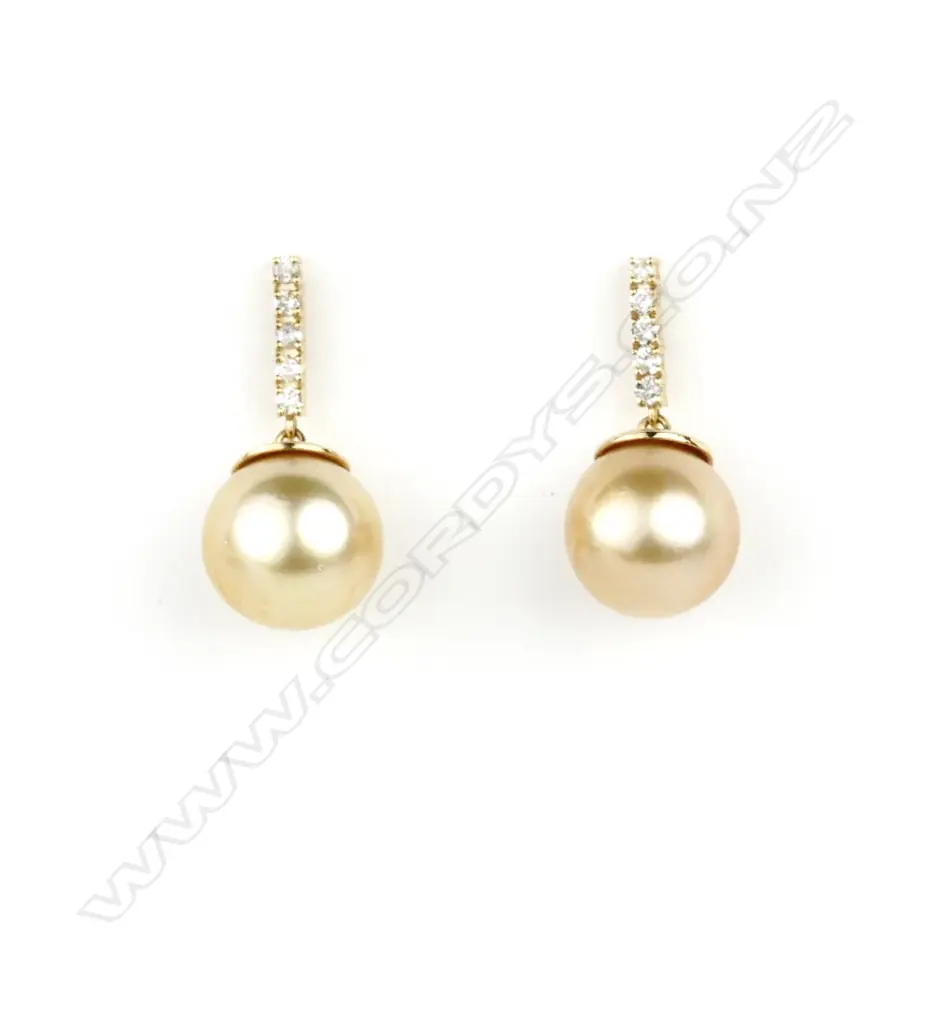 A pair of 14ct. white gold pearl and diamond earrings Image 1++