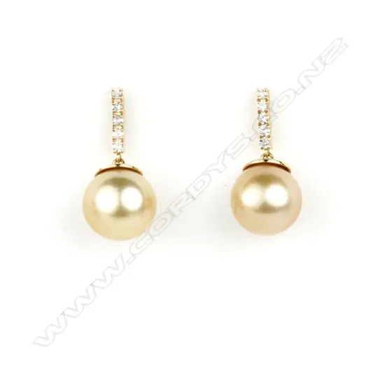 A pair of 14ct. white gold pearl and diamond earrings