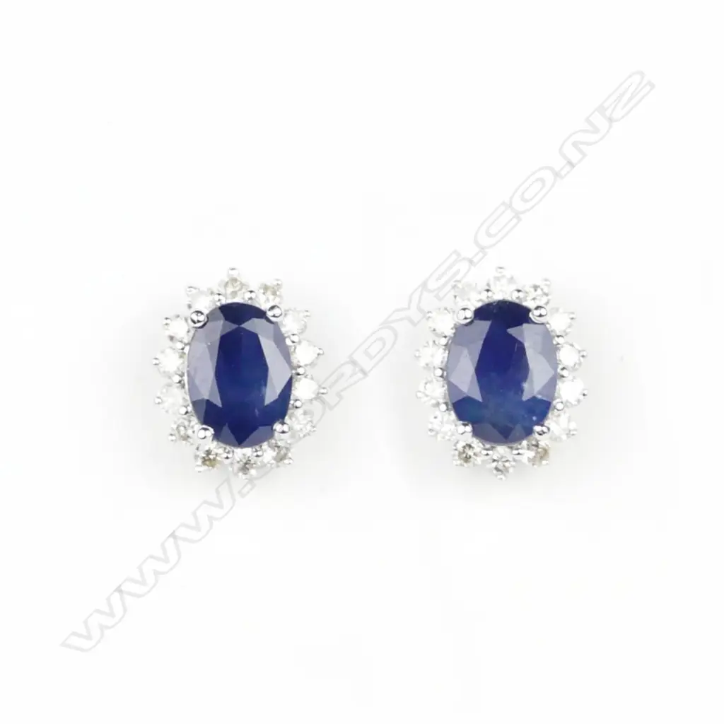 A pair of 14ct. white gold sapphire and diamond stud earrings Image 1++