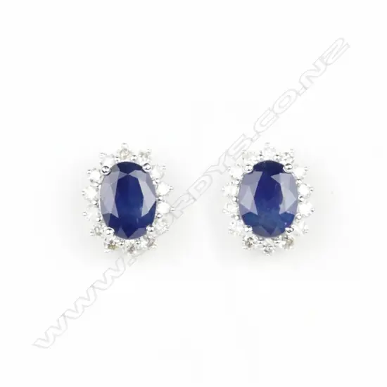 A pair of 14ct. white gold sapphire and diamond stud earrings