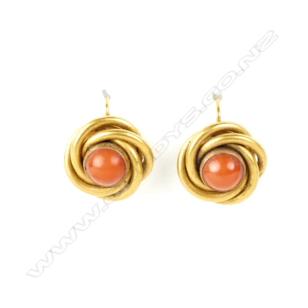 A pair of 15ct. yellow gold and coral knot form earrings Image 1++