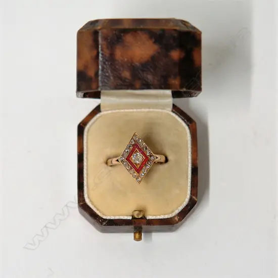 An Art Deco diamond and red enamel stylish ring