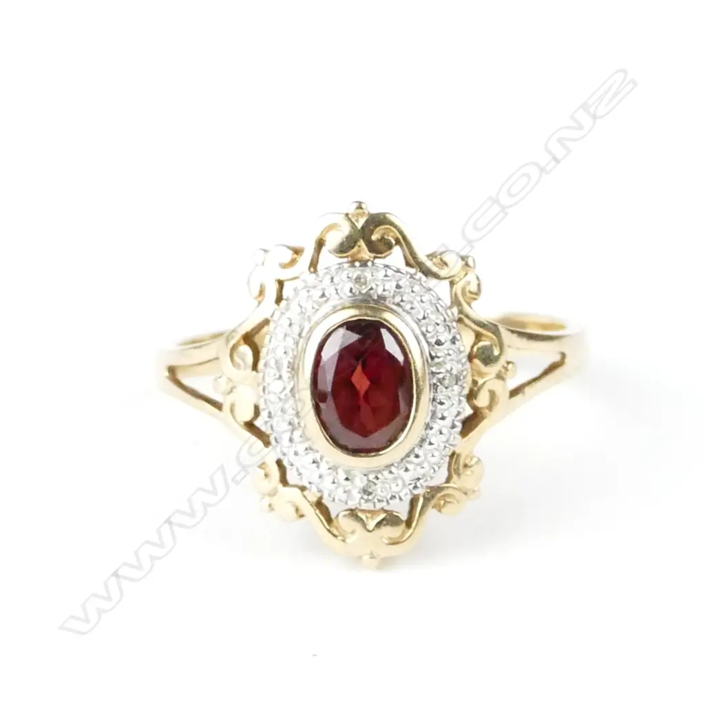 A vintage lady's 9ct. yellow gold garnet and diamond dress ring Image 1++