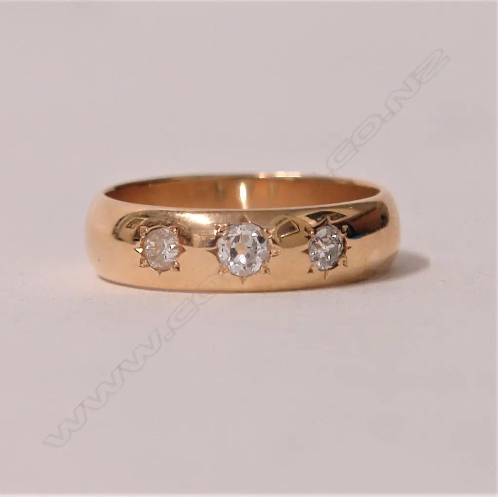 A 14ct. three-stone diamond set gypsy style ring Image 1++