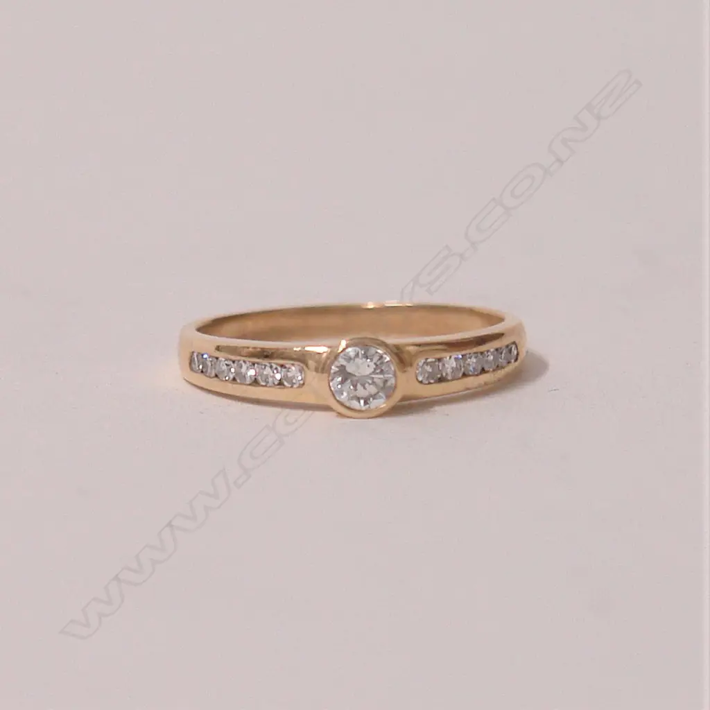 A lady's modern 9ct. yellow gold and solitaire diamond ring Image 1++